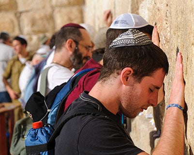 Men praying at the Western Wall in Jerusalem