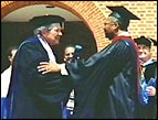 Jacque McDaniel shakes Pat Robertson's hand at Jacque's Regent University graduation
