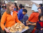 Sondra distributes bread in Peru