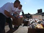 Volunteers pack boxes of food and relief for Hurricane Sandy victims.