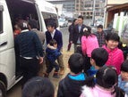 Children unload from their new bus that can now take them on field trips a safe distance away.