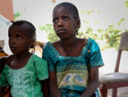 Twelve-year-old Koumba, right, was hit by shrapnel during an attack in her village.