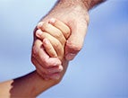 father holding hand of child