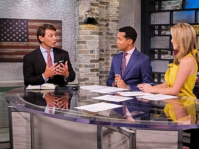 CBN News Faith Nation anchors John Jessup and Jenna Browder interview a guest on set in the Washington, D.C., bureau.