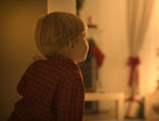 daily Devotion picture child peeking into room decorated for Christmas