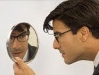 daily Devotion clean-cut man looking in mirror wearing a suit
