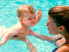 mother with  infant baby swimming in a pool