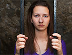 woman behind bars
