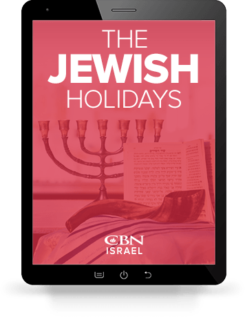 An iPad with an image of the downloadable Jewish Holidays Guide displaying.